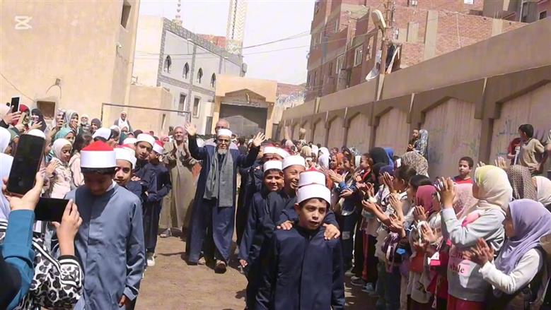 بالزي الأزهري طلاب معهد ديني ببني سويف ينظمون ممر شرفي لأمين التغذية لخروجه على المعاش