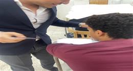 سماعة داخل أذنه.. ضبط طالب متلبسًا بالغش في لجنة امتحانات بـ«حقوق أسيوط» (صور)